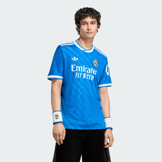 Person wearing a blue sports jersey with visible branding on a white background