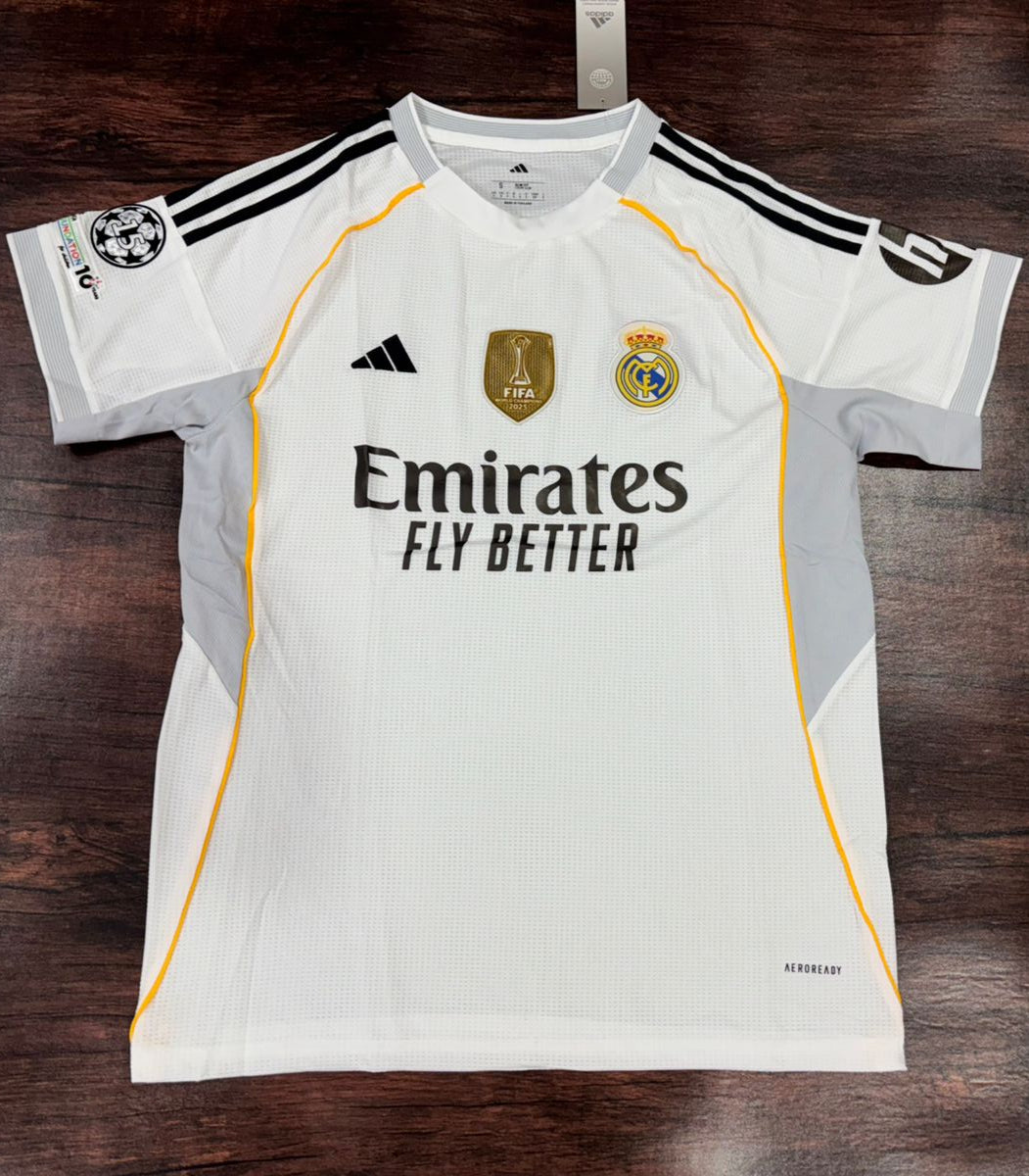White sports jersey with branding on a wooden surface